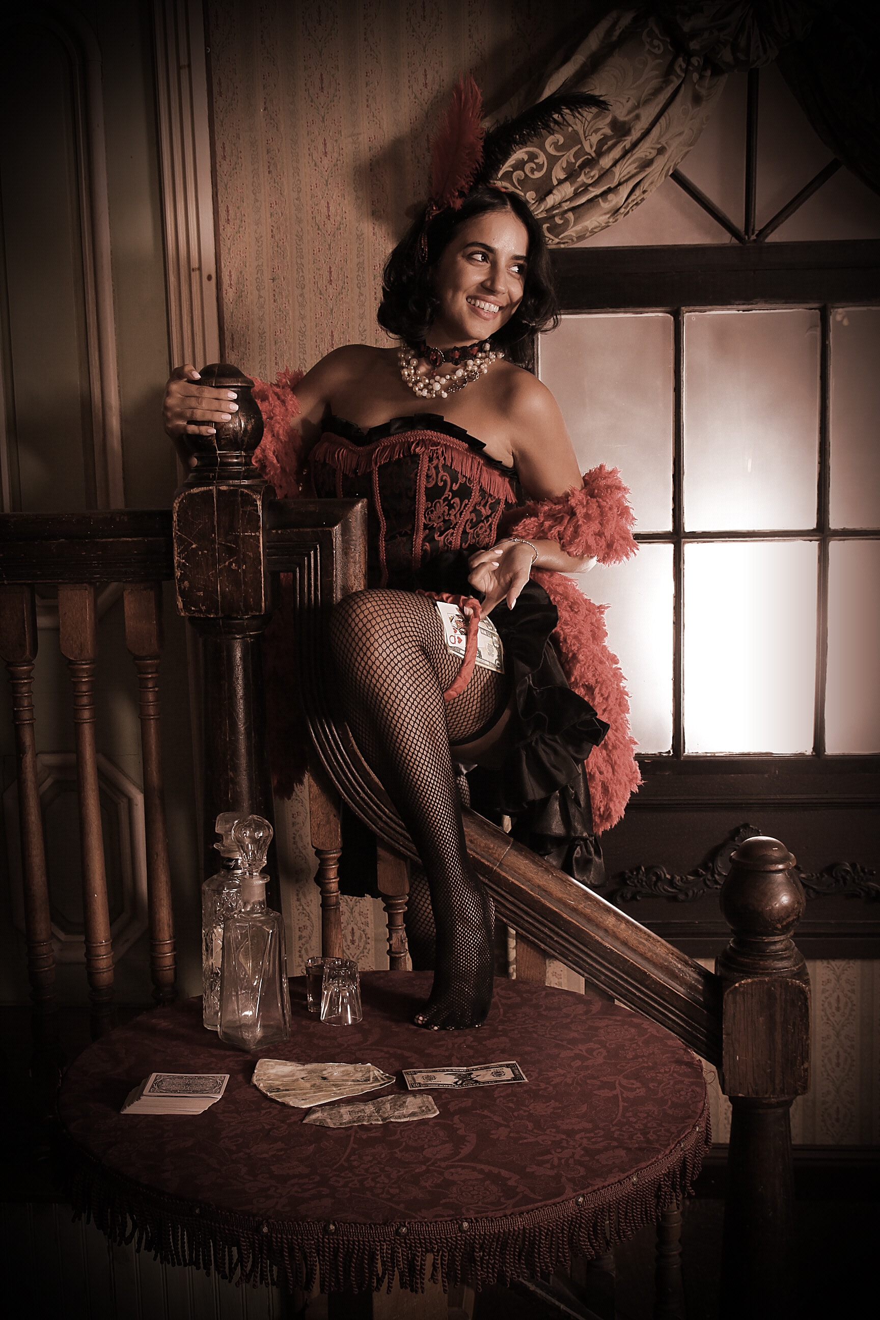 Woman in saloon costume on staircase with playing cards