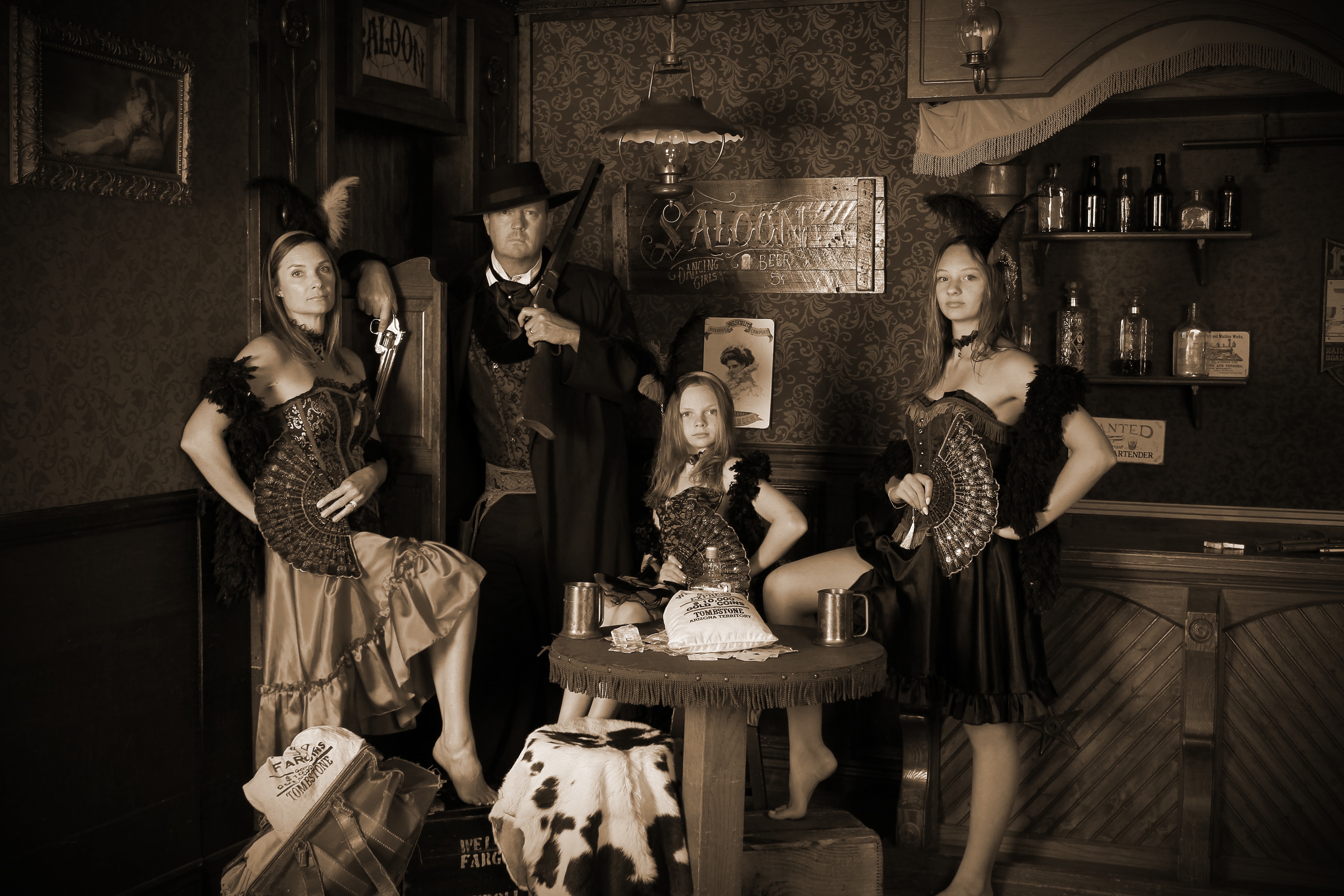Western saloon family portrait with guns and fans