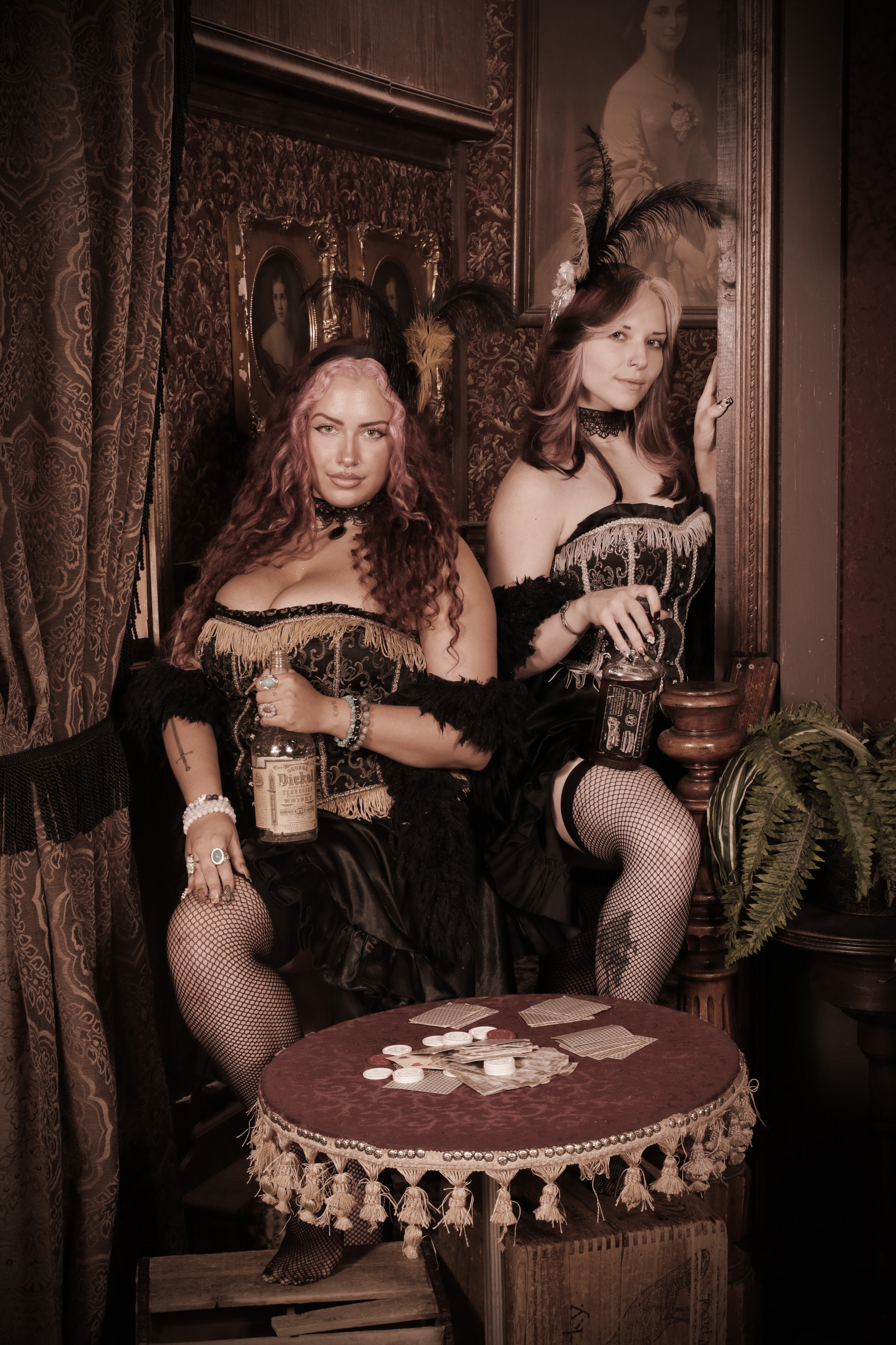Two women in saloon costumes at poker table
